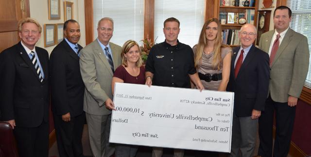 Sun Tan City has pledged $10,000 to continue their corporate sponsorship and to make an additional contribution to the Campbellsville University Scholarship Fund in each of the next four years. From left are: Benji Kelly, vice president for development, and Chuck Vaughn, director of planned giving, both from CU; Amy Smith, regional manager; Mark Nelson, vice president of operations, a 2011 MBA CU graduate; Erin Kenady, district manager; Dr. Michael V. Carter, CU president; Dr. Joseph Owens, chair of the CU Board of Trustees; and Dr. Ted Taylor, director of CU’s Big Maroon Club. Sun Tan City has been a corporate sponsor for the last four years. (Campbellsville University Photo by Yvonne Matheas)